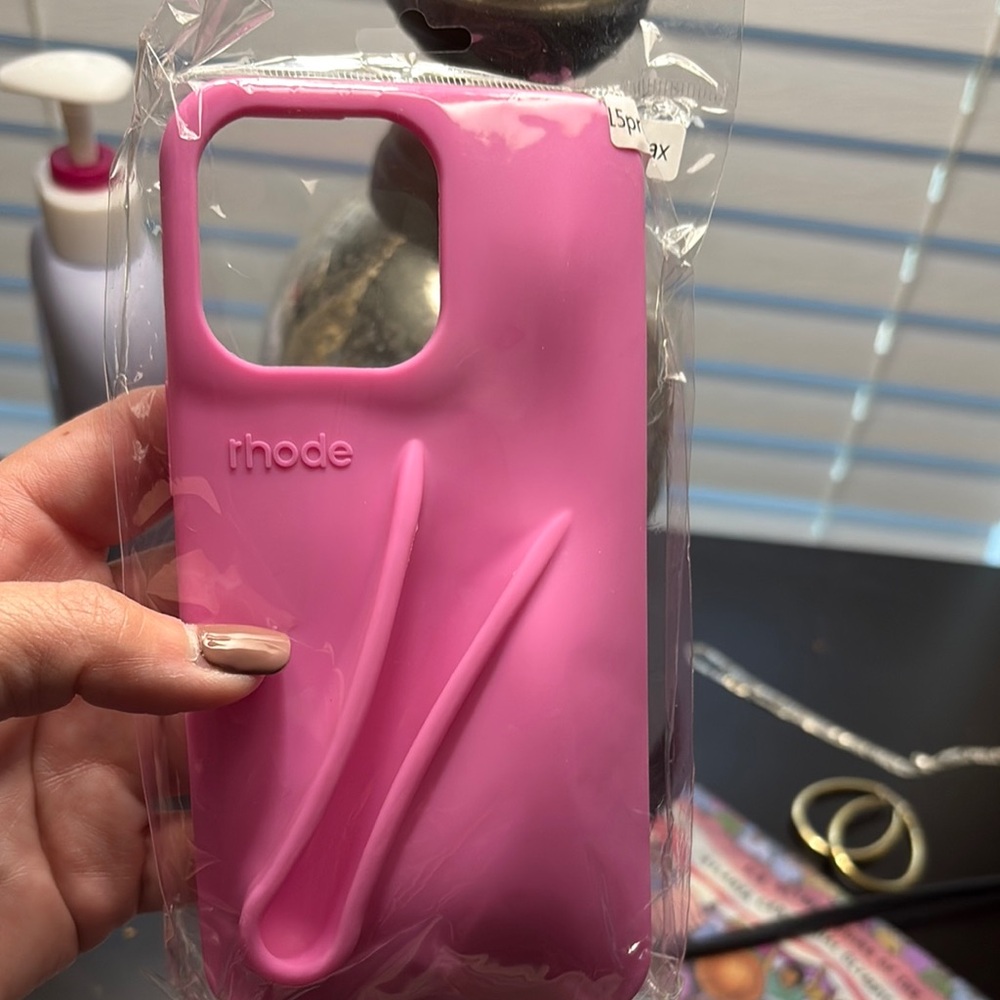 Rhode Pink iPhone 15 pro max case with matching lipgloss.